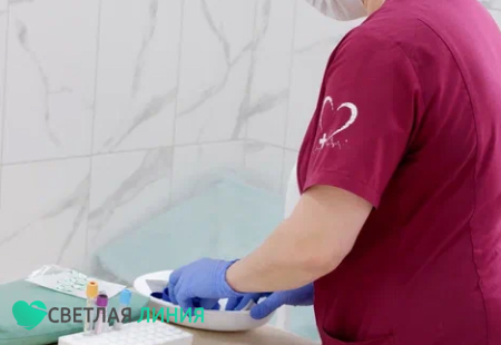 Врач готовится ставить капельницу
